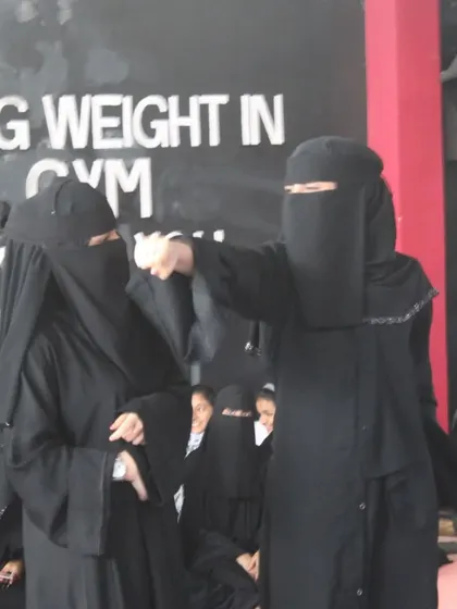 In our dojo, women train with focus and intensity. Here, two of our students in niqab practice their punching techniques, demonstrating that strength and determination are universal.