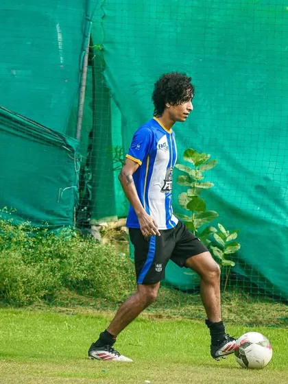 A player calmly controls the ball, looking for the right pass to unlock the defense.