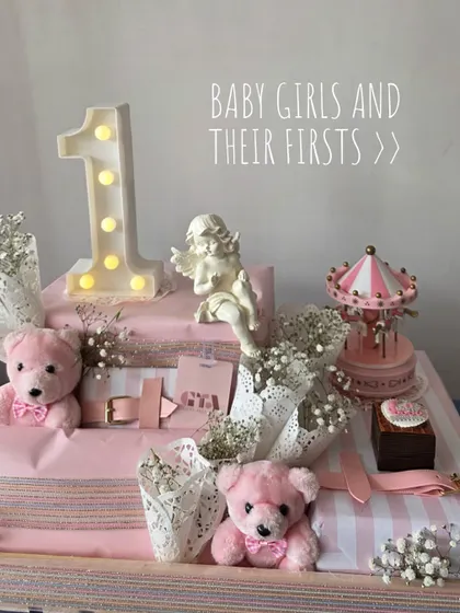 A shot of the first birthday hamper with the text 'Baby Girls and Their Firsts'.