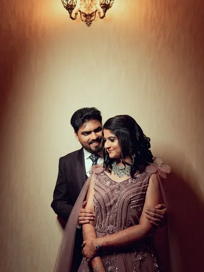 A loving look between a couple at their reception, captured in a warm, intimate portrait.