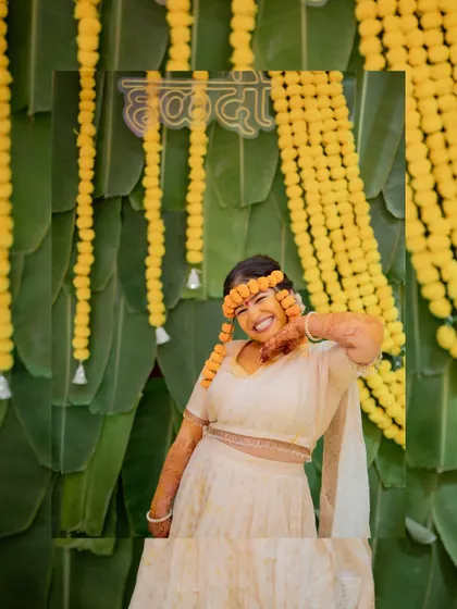 A fun and expressive portrait of the bride against a backdrop of marigold flower decorations.