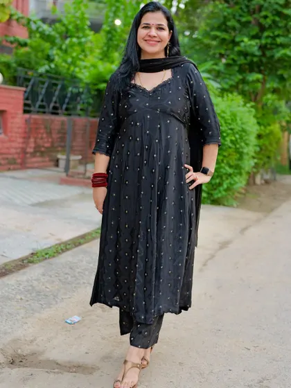 A photo from our anniversary photoshoot. This black suit was created from fabric and is one of my favorite self-designed outfits.