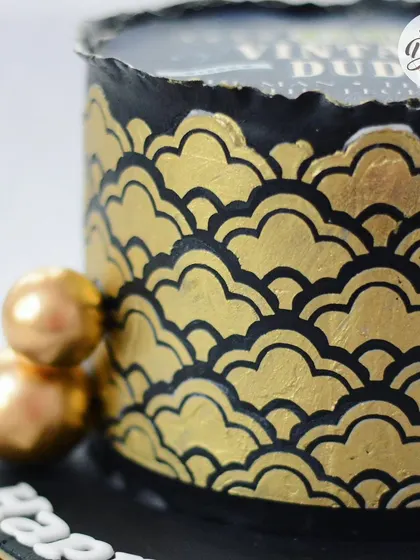 A close-up of the detailed gold and black stencil pattern.