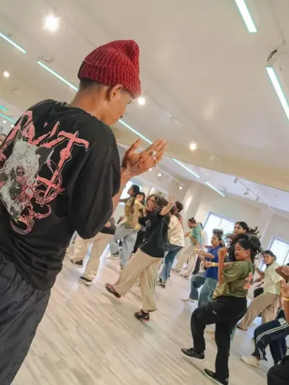 An instructor guiding the class through a complex piece of choreography. Our workshops are designed for focused, hands-on learning.