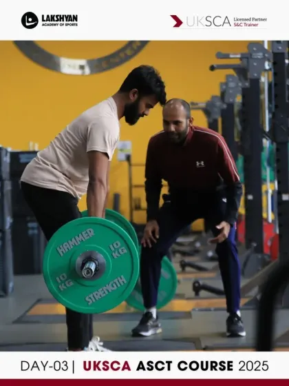 A participant practices the deadlift under the watchful eye of a peer and an assessor. This exercise on Day 3 is crucial for learning to coach posterior chain strength.