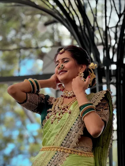 A beautiful light green Nauvari saree for a daytime wedding function. This drape is elegant and allows for easy movement, perfect for enjoying the festivities.