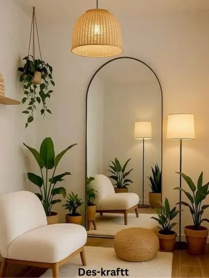 We love creating cozy reading nooks. This corner uses a comfortable armchair, a large arched mirror, and plenty of plants to craft a perfect little escape.