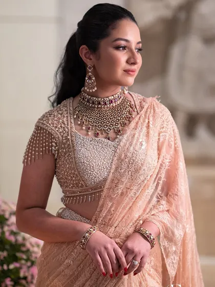 A close-up of the engagement glam, with a chic ponytail and statement jewellery.