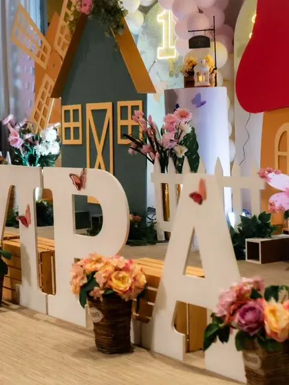 A full view of the butterfly farmland setup, combining the rustic charm of a farm with the delicate beauty of butterflies. The large name blocks are a great centerpiece for photos.
