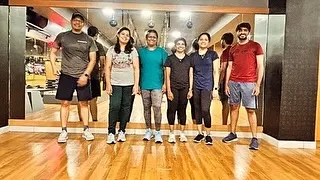 A small group of members, both men and women, posing after a workout. We foster an inclusive environment where everyone feels comfortable and motivated.