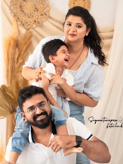 A fun and playful family portrait with a son perched on his father's shoulders. These are the moments of joy we love to freeze in time.