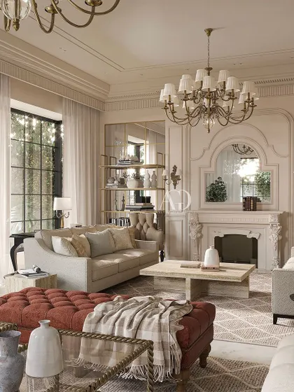 A closer look at the details of this inviting living room. The tufted ottoman in a rich terracotta adds a pop of color and texture, while the classic mantelpiece and mirrored alcoves enhance the room's sophisticated, European-inspired character.
