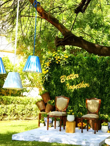 Another view of the couple's seating, showing hanging lamps that add a modern touch to the rustic, nature-inspired decor.