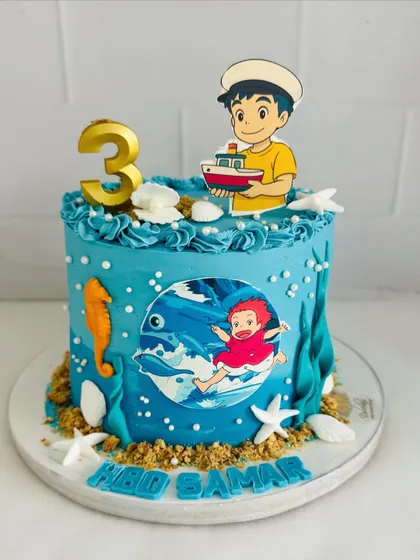A full shot of the beautiful Ponyo-themed cake, capturing the innocence and wonder of the sea.