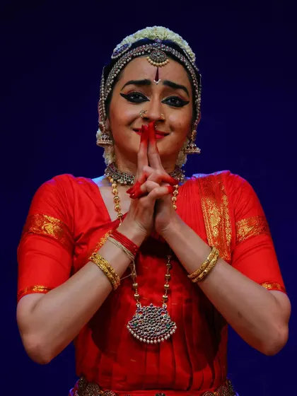 A close up of a gesture of offering, with hands cupped as if holding sacred water or flowers for the deity.