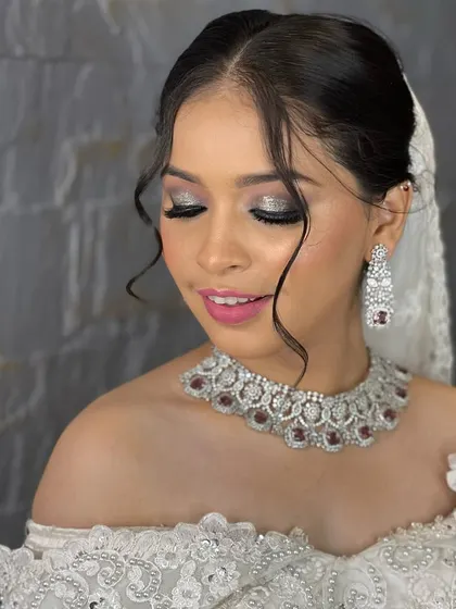 This client looks absolutely gorgeous for her reception or cocktail party. She rented this stunning silver-toned choker with ruby-red stones, which adds a perfect pop of color to her elegant white off-shoulder gown.