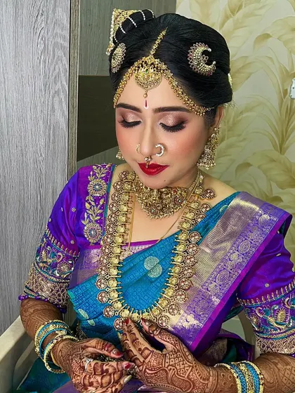 A traditional Iyengar bridal look, complete with the Andal Kondai hairstyle and authentic jewelry. The makeup is kept classic and elegant to honor the cultural details of the ceremony.