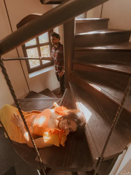 An artistic and conceptual shot on a spiral staircase, telling a story of longing and connection.