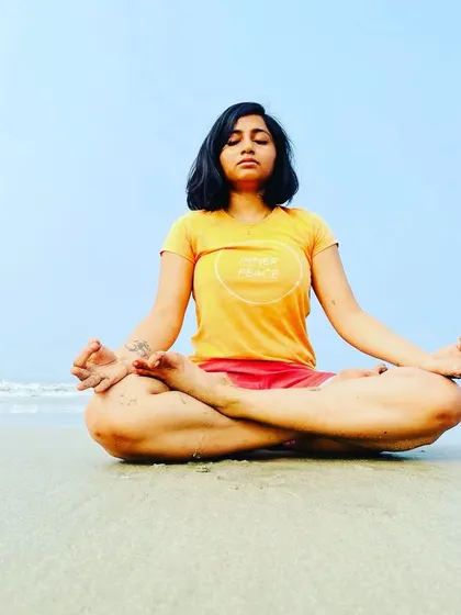 Peace will eventually follow. Enjoy the process. A student meditates on the beach, absorbing the calm and serene energy of the ocean.