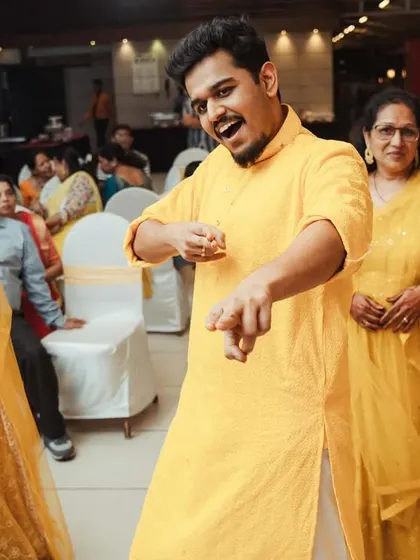 The groom owning the dance floor, pointing to the camera with a huge smile. We love capturing these confident, fun moments.