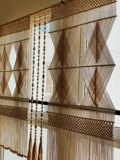 The full macrame partition set, complete with hanging tassels, creating a beautiful and functional room divider.