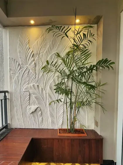 This wider view shows how the sculptural art piece transforms the balcony into a sophisticated outdoor living area. It serves as a permanent, weather-resistant feature wall.