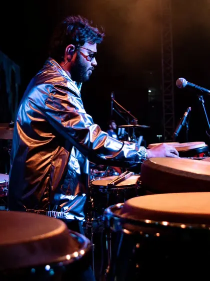 Playing the congas during a college music festival. The energy of a young audience is infectious, and I love performing for them.