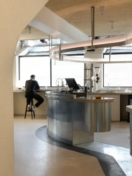 The brew bar in action, with a customer seated at the window counter, enjoying the view.