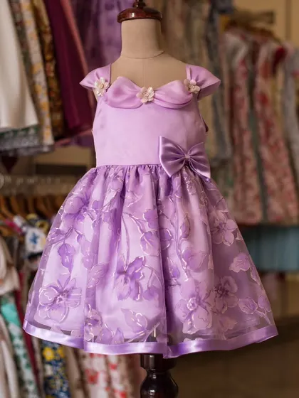 A beautiful lavender dress with delicate floral details. This piece showcases my commitment to creating unique and elegant designs for your little ones.