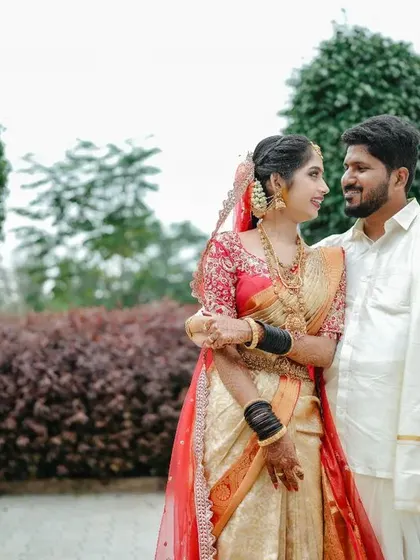 A romantic portrait of a newly married couple, sharing a quiet moment together in a garden.