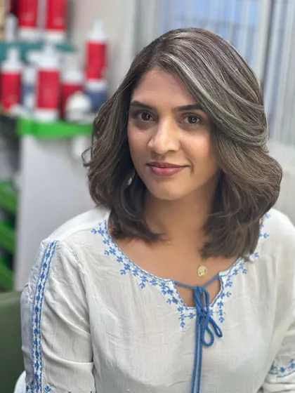 The client looking happy and refreshed with her new ash brown hair.