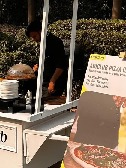 For corporate events, I can create a fully branded setup. Here is my "adiclub Pizza Cafe" cart, custom-made for an employee event at Adidas India.