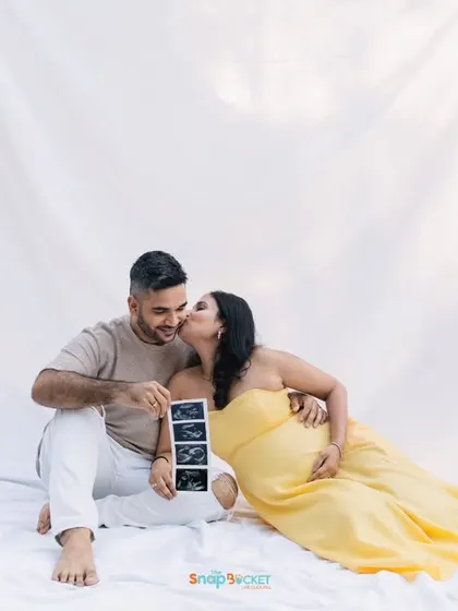 A sweet kiss and a big announcement! This family used their outdoor session to share the news with an ultrasound photo. It’s a beautiful way to include the whole family in the excitement.