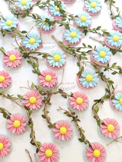A close-up of the daisy flower soy wax sachets in pink and blue, created for Aishwarya's baby shower in Mumbai.