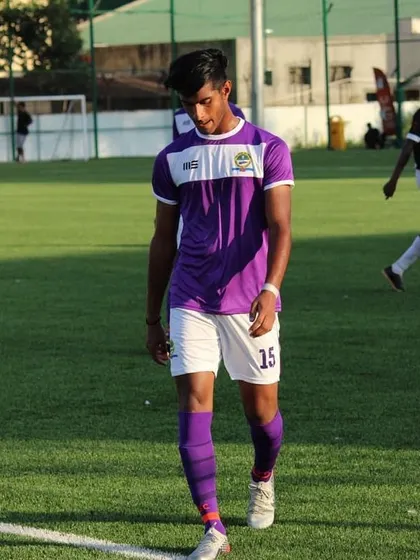 Samanyu Nag in his purple away kit, a picture of focus and determination on the field.