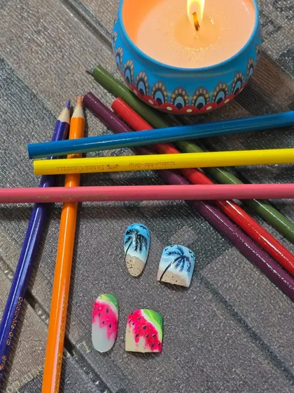A close-up of the beach and watermelon themed matching nail art set. These designs are perfect for clients looking for a coordinated look for their vacation.