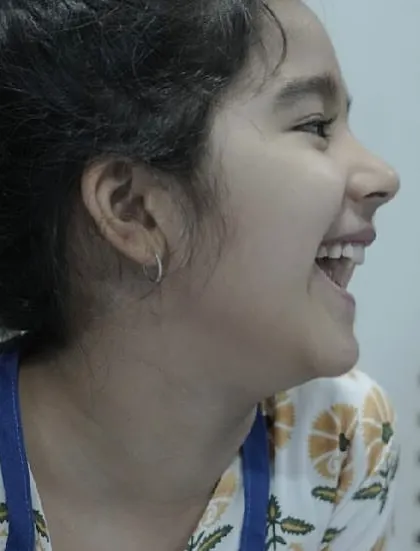 A candid shot of a student's infectious laughter. These are the moments of pure, unscripted joy that make the process so special.