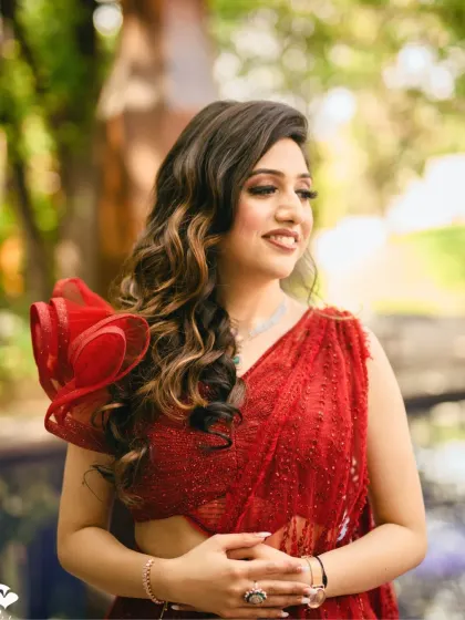 A candid, smiling shot of the bride. Her makeup is soft and natural, allowing her joyful expression to be the focus.