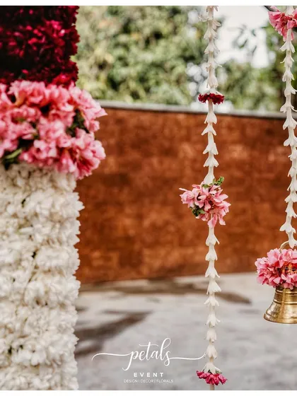 Another beautiful detail shot of a temple bell, surrounded by floral garlands.
