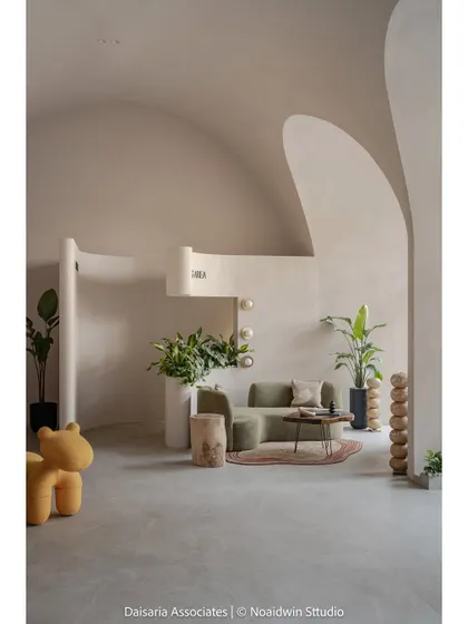 A minimalist composition showing the waiting area with its clean lines, organic forms, and the playful yellow bear-shaped seat.