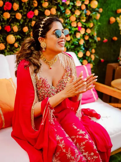 Our stunning bride, looking chic in sunglasses, enjoying the music and atmosphere at her vibrant Haldi party.