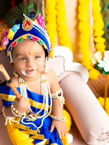 A delightful close-up of a smiling baby Krishna with a touch of "butter" on his face, holding his flute. It's these small details that bring the theme to life.