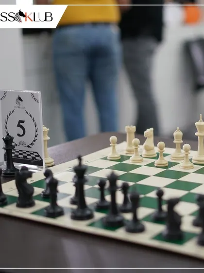 A close up of a chessboard mid-game, capturing the quiet intensity of a competitive match. Every piece and every move counts in our tournaments.