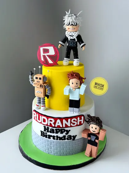 A Roblox-themed cake with custom characters. This three-tiered cake brings the popular game to life with edible figurines modeled after the birthday boy's favorite avatars.