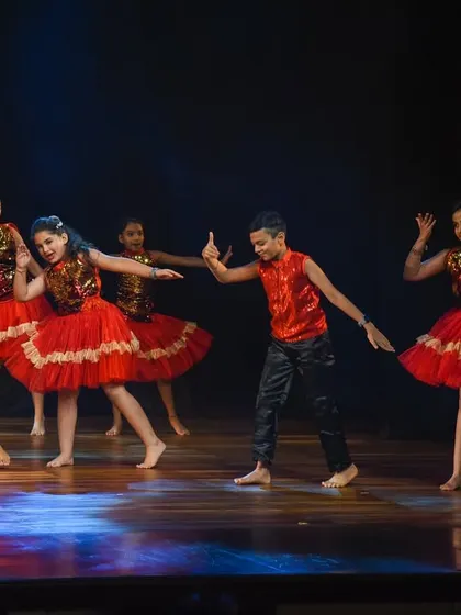 A moment of graceful interaction between the dancers during their choreographed Bollywood piece.
