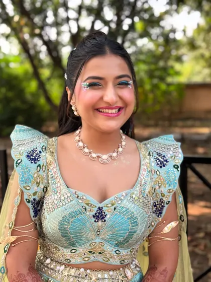 The bride's happy face says it all. The fun, carnival inspired hairstyle perfectly matches her joyful energy and the festive theme of the event.
