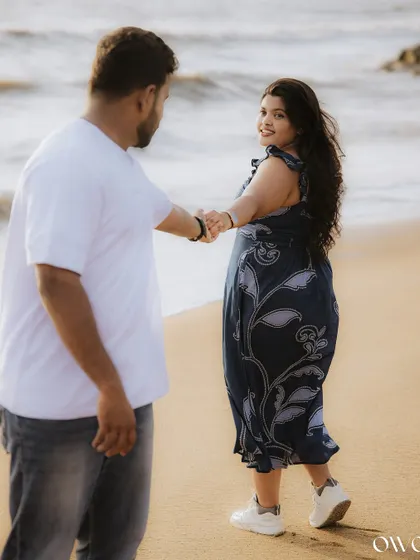 A beautiful shot of the couple walking hand-in-hand on the sand, capturing the romance of a beachside save-the-date session.