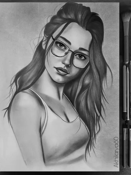 An example of my graphite portrait work on A3 paper. I love drawing with this medium to create dramatic lighting and focus on expression, like in this portrait of a girl with glasses.