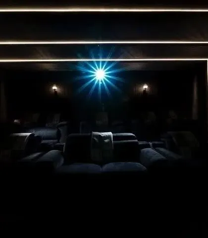 The projector is the heart of the visual experience. Here, the bright beam cuts through the darkness, illuminating the screen with a crystal-clear image.