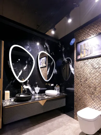 The full view of the vanity area, which includes a textured gold accent wall and a modern floating toilet.